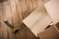 Top view of cardboard boxes with hammer and nails on wooden floor