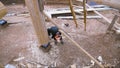 Top view of carpenter building new wooden ecological house or cottage in the countryside area. Clip. Male worker wearing Royalty Free Stock Photo