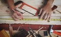 Top View of Carpenter Working in Woodworking Workshop. Measuring