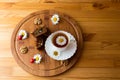 Top view of carrot cakes in a section with walnuts and spices,a white porcelain Cup with a saucer and tea, walnuts, daisies with Royalty Free Stock Photo