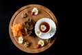 Top view of carrot cakes in a section with walnuts and spices,a white porcelain Cup of tea, walnuts, daisies with ladybirds and Royalty Free Stock Photo