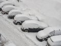 Top view of cars covered by snow after winter storm