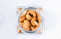 Cashew nuts in clear bottle on white background