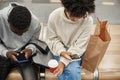 casual young couple using their smartphones waiting for the subway train . Royalty Free Stock Photo