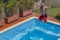 Top view of a caucasian man that takes a funny dive in the swimming pool on a sunny day Royalty Free Stock Photo