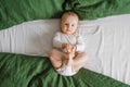 Top view of a Caucasian 6-month-old boy holding his legs and looking at the camera Royalty Free Stock Photo