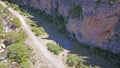 Top view of the cave, forest, rocks and road.