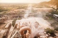 Top view of cement factory, dusty and steam was blowing in the factory, village and mountain in the dust in the evening, hot Royalty Free Stock Photo