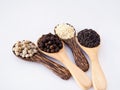 Top view of cereal herbs in wooden spoon with white pepper, black pepper, black sesame and white sesame. Royalty Free Stock Photo