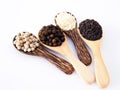Top view of cereal herbs in wooden spoon with white pepper, black pepper, black sesame and white sesame. Royalty Free Stock Photo