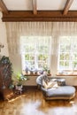 Top view of a chaise longue, windows and curtains in a classic style house interior