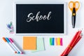 top view of chalkboard with lettering school and arranged variety stationery