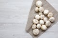 Top view, champignon mushrooms over white wooden background. From above, overhead. Royalty Free Stock Photo