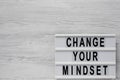 Top view, `Change your mindset` words on a lightbox on a white wooden background. Overhead, from above, flat lay. Copy space Royalty Free Stock Photo