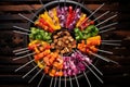 top view of a charcoal grill with colorful skewers
