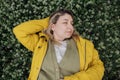 Top view of a charming young woman has closed her eyes and is lying on a blooming meadow Royalty Free Stock Photo