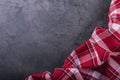 Top view of checkered kitchen tablecloth on granite - concrete - stone background. Free space for your text or products Royalty Free Stock Photo