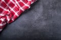 Top view of checkered kitchen tablecloth on granite - concrete - stone background. Free space for your text or products Royalty Free Stock Photo
