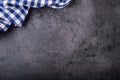 Top view of checkered kitchen tablecloth on granite - concrete - stone background. Free space for your text or products Royalty Free Stock Photo