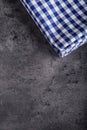 Top view of checkered kitchen tablecloth on granite - concrete - stone background. Free space for your text or products Royalty Free Stock Photo