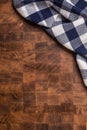 Top of view checkered tablecloth on empty wooden butcher board