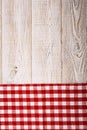 Top view of checkered tablecloth on white wooden table. Royalty Free Stock Photo