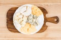 Variety of cheese kinds on wooden board