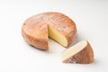 Top view of cheese wheel and slice on white. Royalty Free Stock Photo
