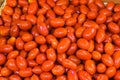 Cherry tomatoes on the counter of the vegetable market. Close-up and top view of fresh vegetables on store shelves. Royalty Free Stock Photo