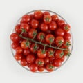 top view cherry tomatoes in glass bowl isolated on white background