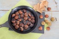 Top view of Chestnuts, maroni. Roasted chestnuts in black pan Royalty Free Stock Photo