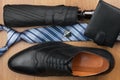 Top view, chic classic men`s shoes, tie, wallet, umbrella and cufflinks