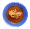 Top view chicken Mussaman Curry - spicy Muslim curry in blue dish on white