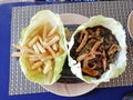 Top view chicken Sizzler served in cabbage leaves.