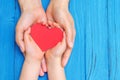 Child and dad hands holding red heart Royalty Free Stock Photo