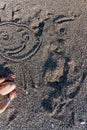 Top view of a child drawing smiley face in a sand Royalty Free Stock Photo