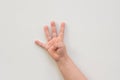 Top view of child hand showing four fingers as number four on the white background Royalty Free Stock Photo