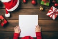 AI generated. Top view of child hands on empty paper blank for writing wish present list on wooden background Royalty Free Stock Photo