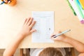 Top view of child hands with pencils. Solving maths exercises Royalty Free Stock Photo