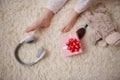 Top view child's feet on a carpet near wireless headphones, hairbrush, gift box and plush toy Royalty Free Stock Photo