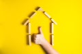 Top view of child`s hand close up building blocks showing ok, house, wooden hut Royalty Free Stock Photo