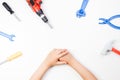 Top view on child`s hands playing with colorful toys tools on the white background. Royalty Free Stock Photo