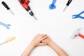 Top view on child`s hands playing with colorful toys tools on the white background. Royalty Free Stock Photo