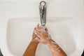 Top view of a child washing her hand in washbasin