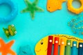 Top view on children`s educational and music games, frame from multicolored kids toys on light blue paper background. Circles, Royalty Free Stock Photo