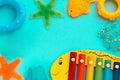 Top view on children`s educational and music games, frame from multicolored kids toys on light blue paper background Royalty Free Stock Photo