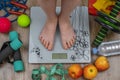 Top view of children& x27;s feet on floor scales, next to floor is fitness set for fitness. Children& x27;s health and Royalty Free Stock Photo