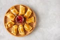 Top view of chilean empanadas on a wooden plate with ketchup. Wh