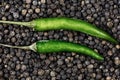 Top view of chili pepper green pod closeup black peppercorn. pair parallel pods