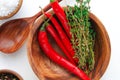 Top view: chili and thyme in bowl on white wooden table